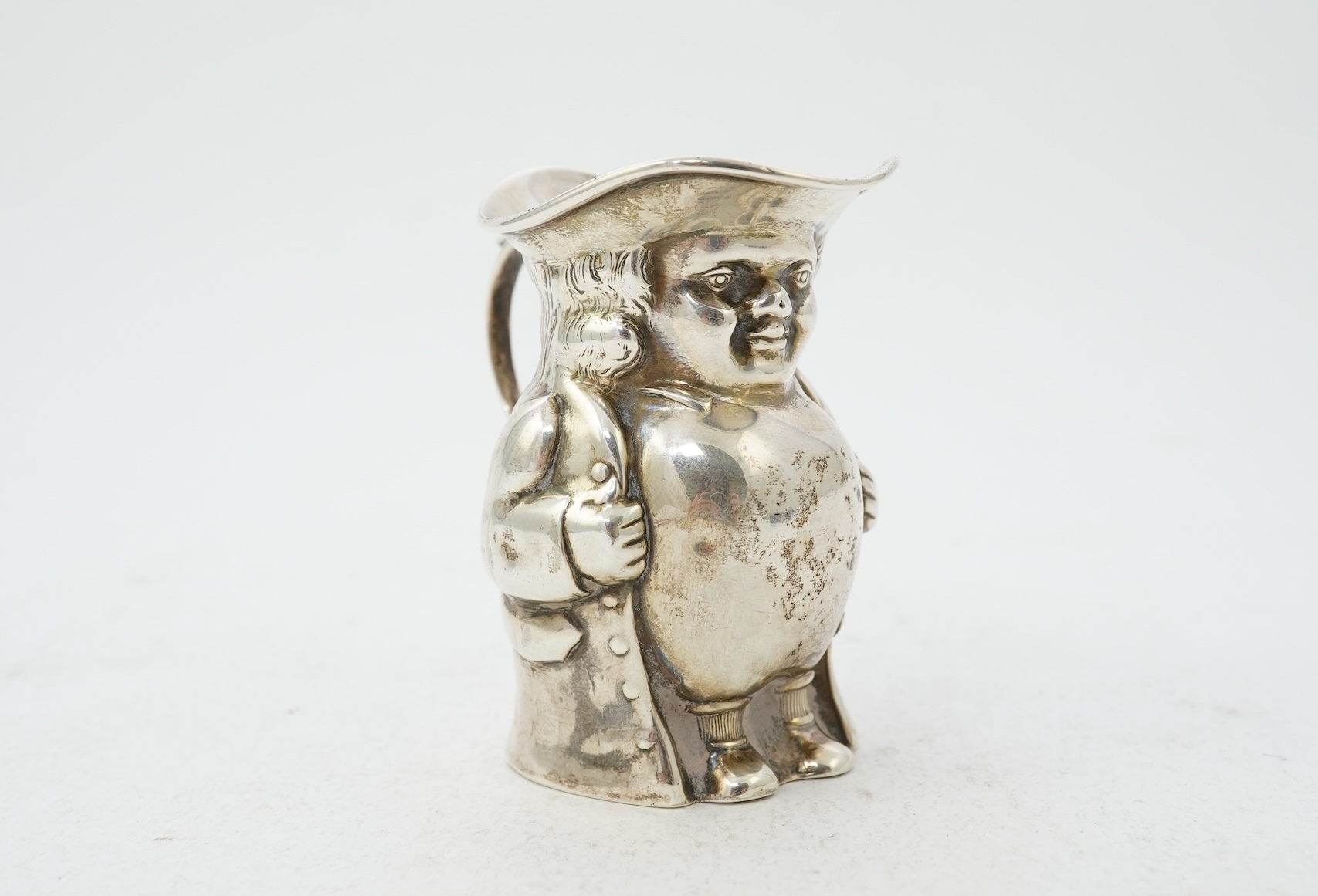 A George V novelty silver cream jug, modelled as a Toby Jug, by Hayes & Co